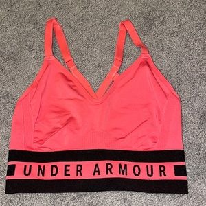 Salmon pink colored Under Armour sports bra